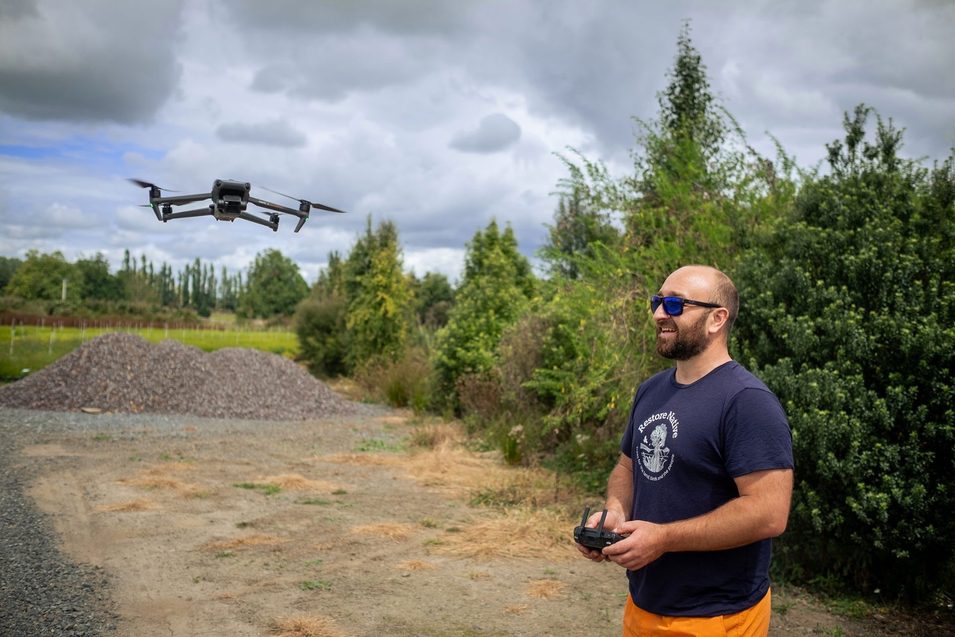 Restore Native team member flying a drone over a restoration site